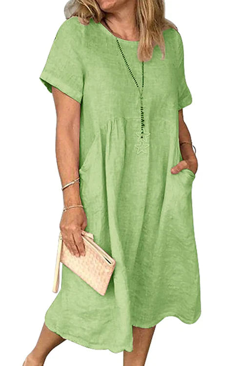 – Kleid aus Baumwollleinen mit kurzen Ärmeln und Taschen und Rüschen